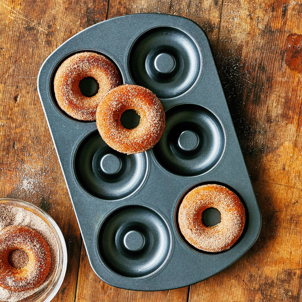 the pan with six circular crevices to make donuts in