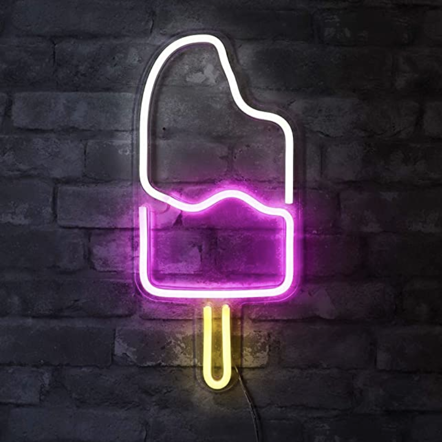 An neon white, pink, and yellow ice cream light on a brick wall