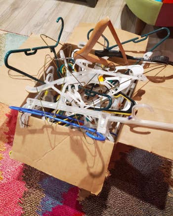 Hangers thrown messily into cardboard box