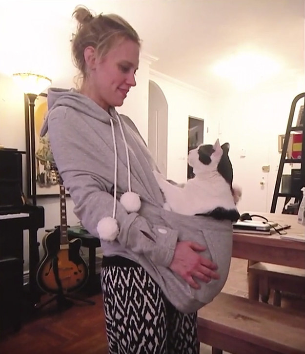 Kate holding her cat inside her hoodie