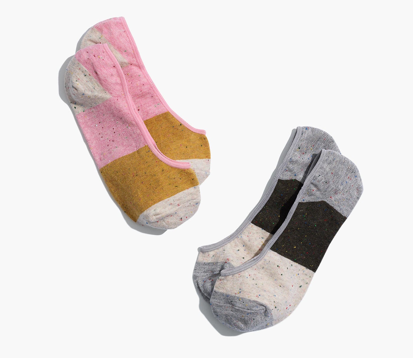 A pink, yellow, ivory pair of a black, gray, ivory pair of rainbow speckled socks