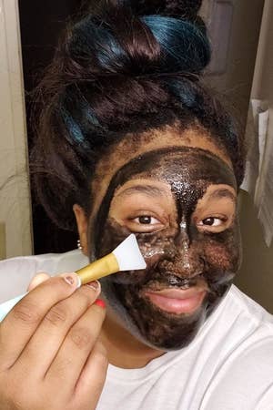 A reviewer applying a face mask with the silicone brush 