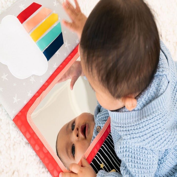 A baby model playing with a project