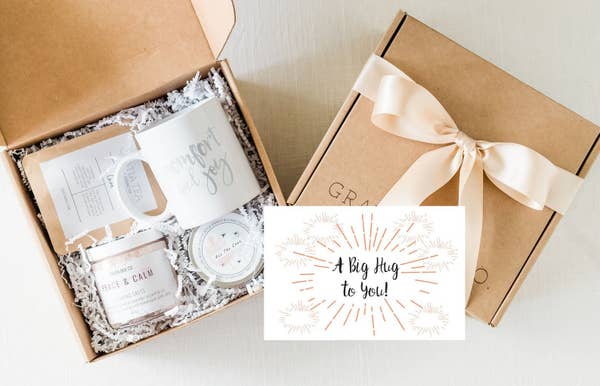 gift box open with mug, scrub, and tea
