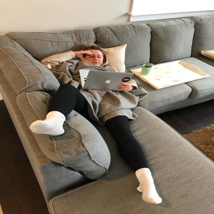 BuzzFeed writer lounging on a couch in the leggings