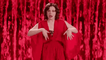 Rachel Bloom dancing in a red dress meant to look like period blood 