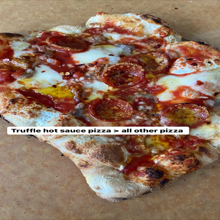 a delicious looking pepperoni pizza with truffle sauce on it and the caption "truffle hot sauce pizza is greater than all other pizza"