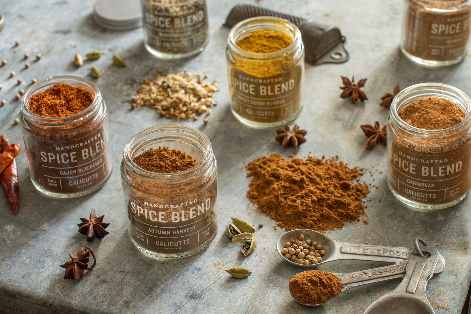 a variety of spices in jars styled on a table