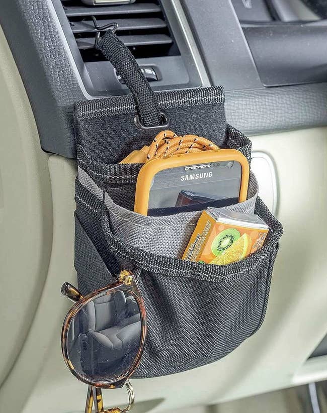 pocketed pouch-like organizer hanging from a car vent