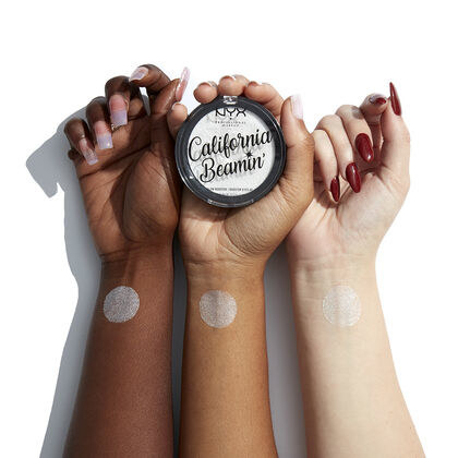 three forearms of people with dark, medium, and fair skin tones with the silver highlighter swatched on the wrists to show the pigmentation