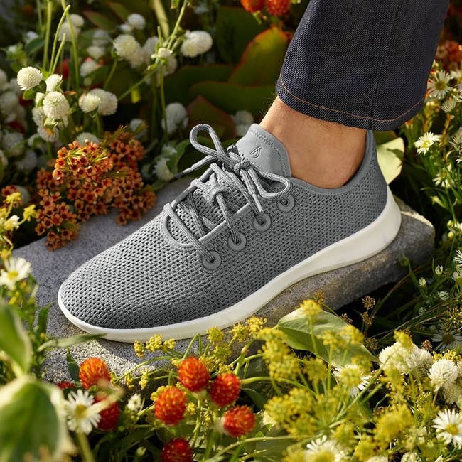 model wearing the knit lace-up sneaker in grey with white sole