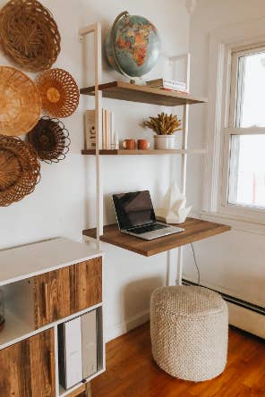 boho style office with the white piping and wood shelf mounted ladder desk