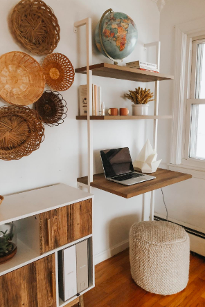 reviewer pic of boho style office with the white piping and wood shelf mounted ladder desk