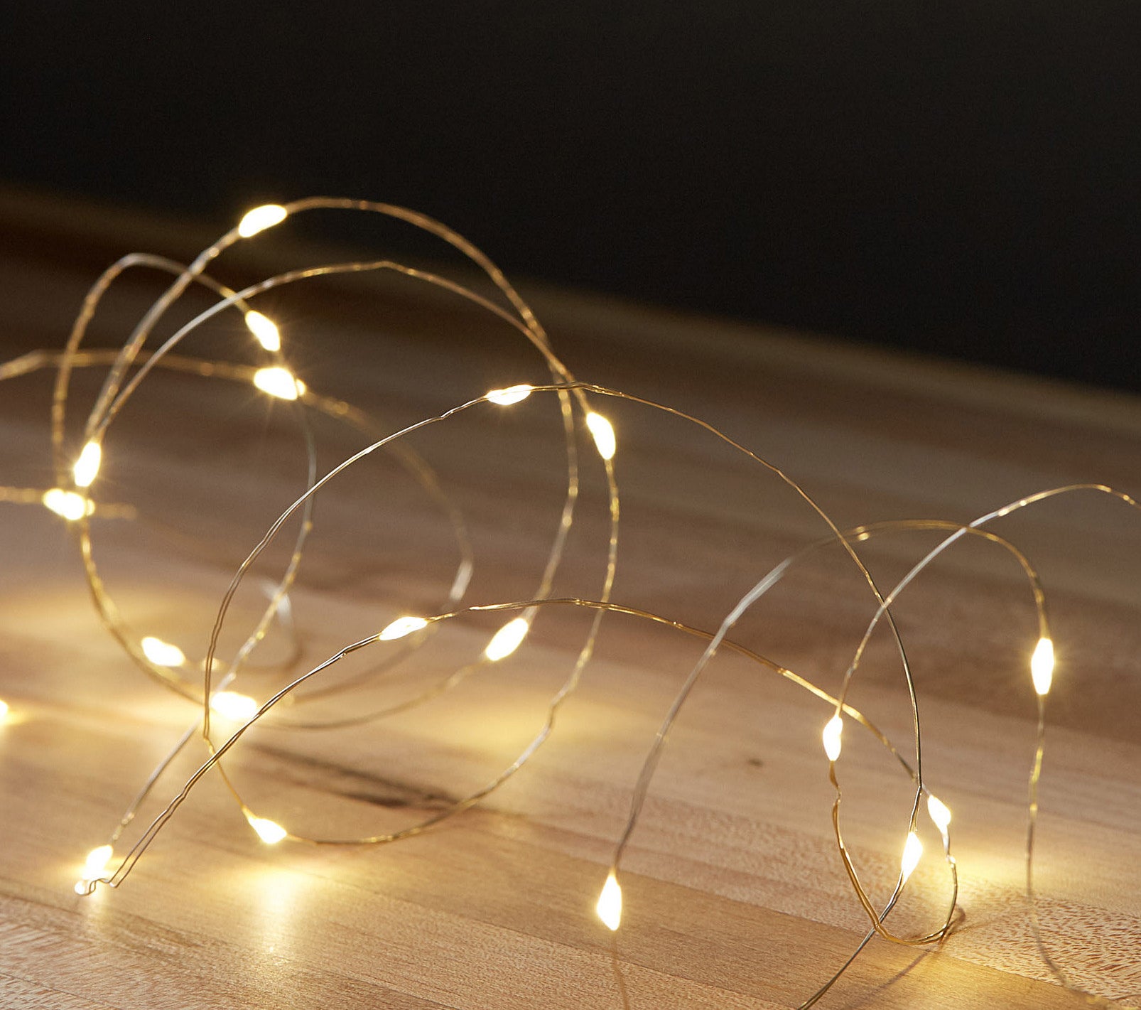 A string of fairy lights on a wooden floor