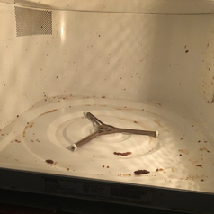 reviewer photo of a dirty microwave 