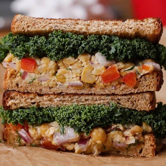 Two halves of a chickpea salad sandwich