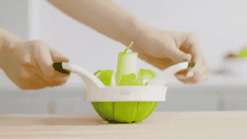 A GIF of the slicing tool in motion cutting a whole apple into a eight pieces and removing the core