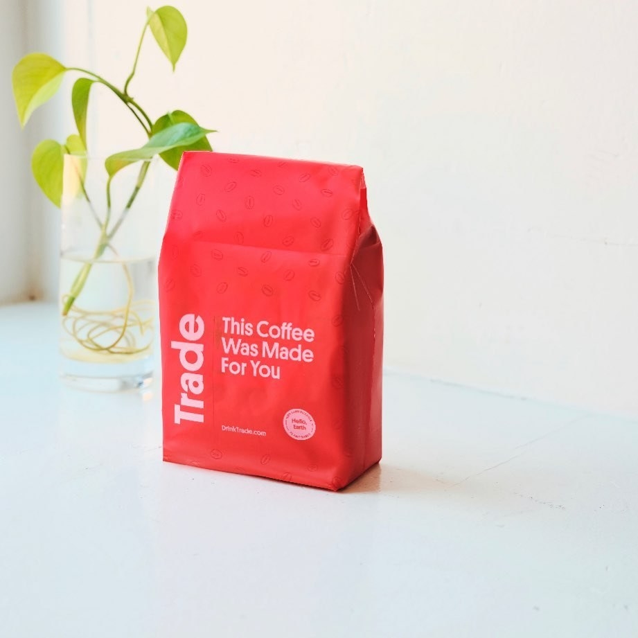 Red coffee bag with the words &quot;Trade&quot; and &quot;This Coffee Was Made For You&quot; on it