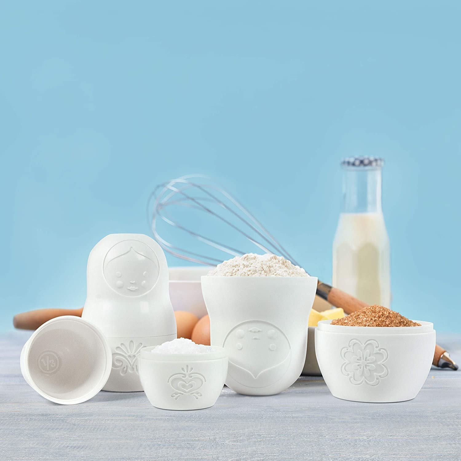 A product shot of the measuring cups filled with sugars 