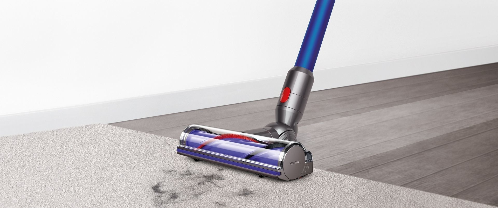 a vacuum cleaner sucking up pet hair from a rug