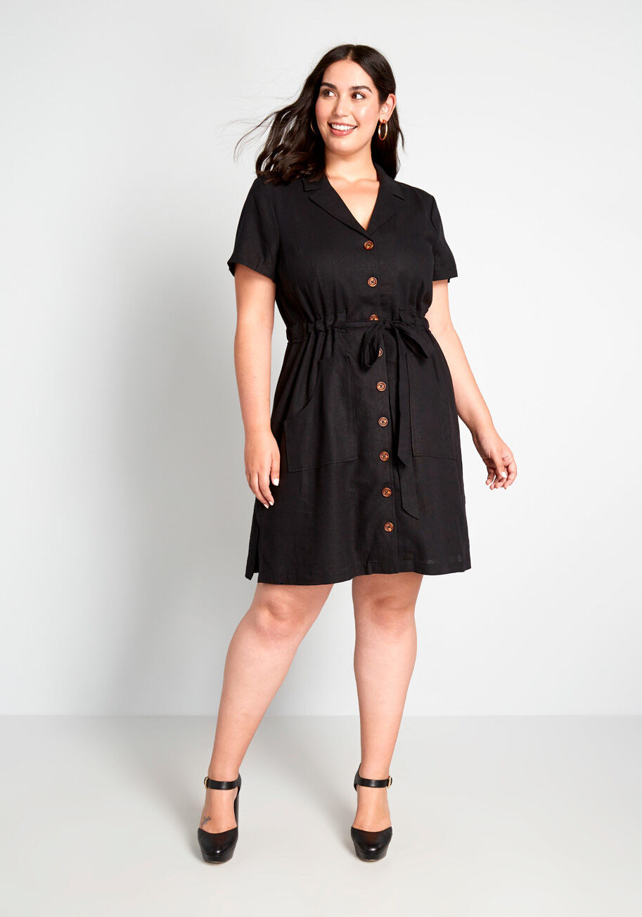 Model wearing woven-fabric shirtdress with marbled buttons down the front, an adjustable tie waist, and pockets