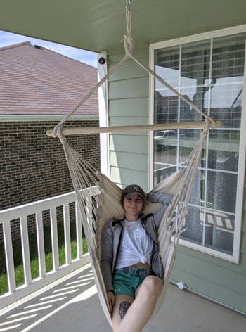 Another reviewer lounges in the same chair on their porch
