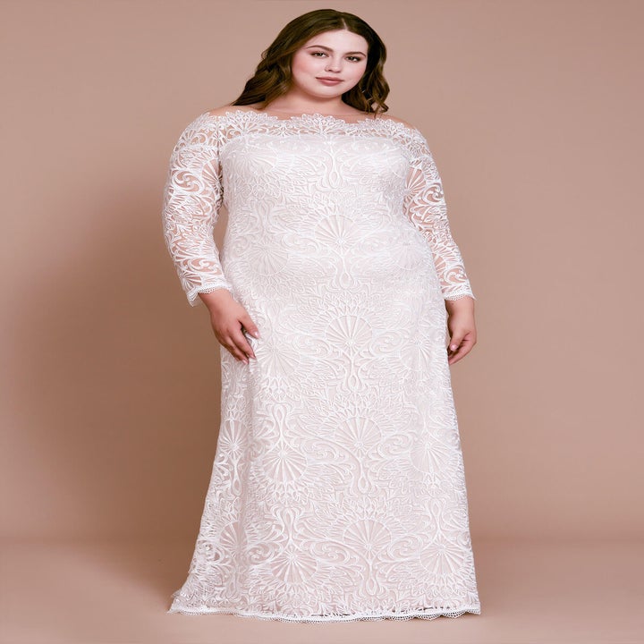 a model wearing a boatneck gown with scallop detailing and delicate long sleeves