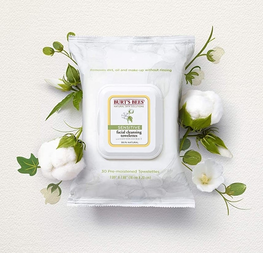 A flatlay of the facial wipes next to some cotton flowers