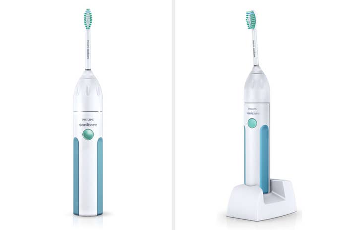 A front and quarter-turn view of a white electric toothbrush with light blue accents and an aqua power button