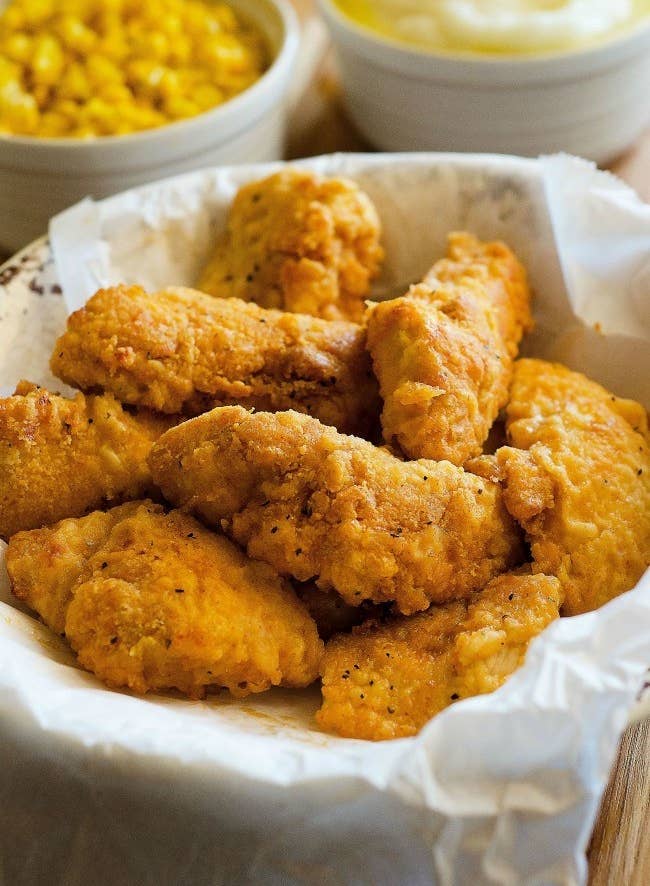 Pieces of golden brown crispy chicken tenders.