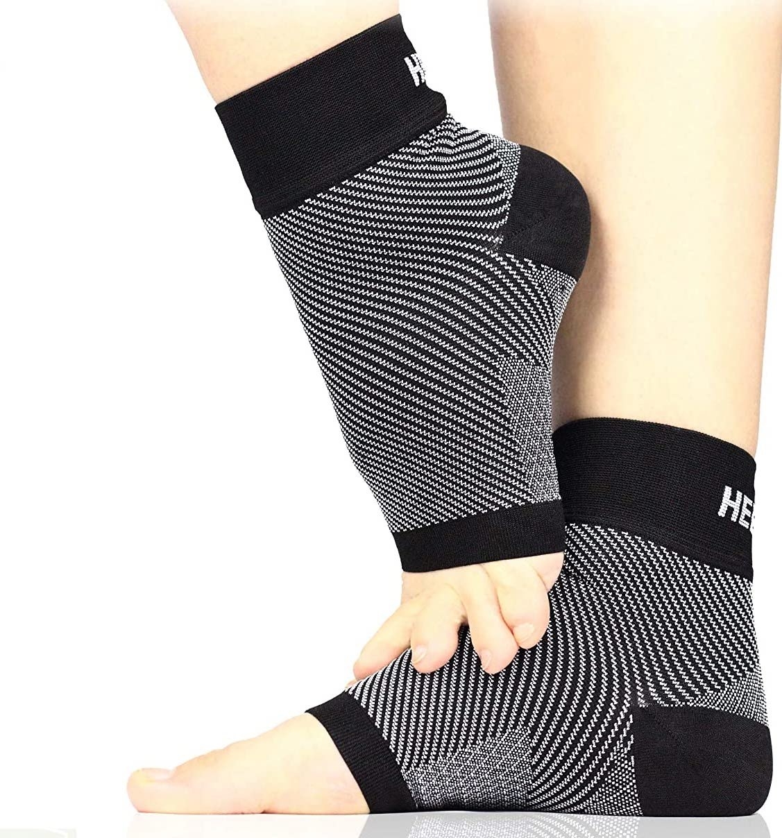 A close-up photo of the compression sleeves on a pair of feet