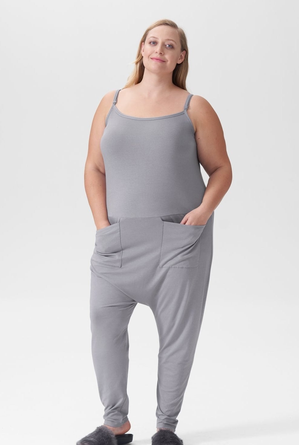 model in grey jumpsuit with hands in two large front pockets