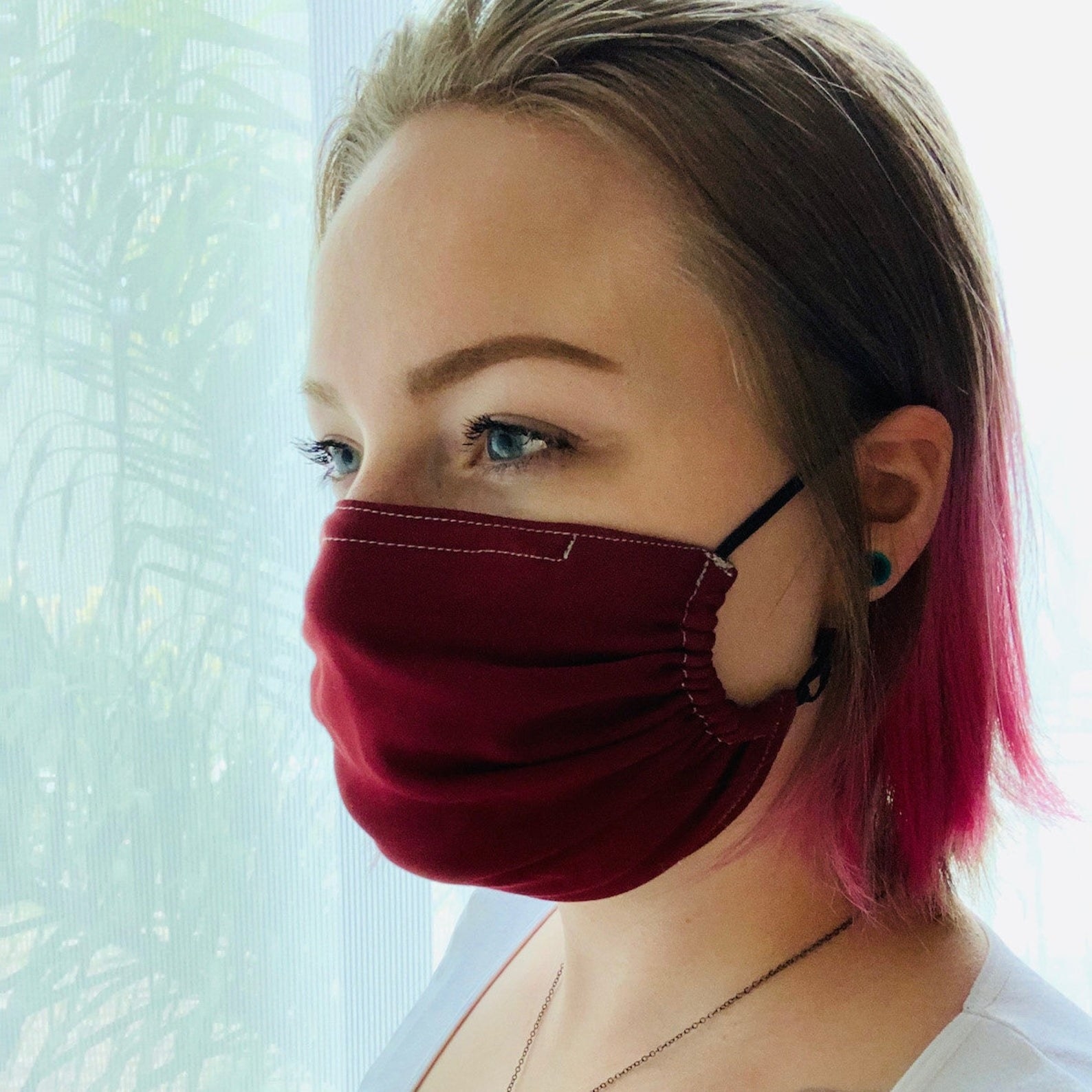 A model in a red face mask