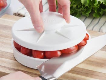 The same slicer but with a number of cherry tomatoes being sliced all at once
