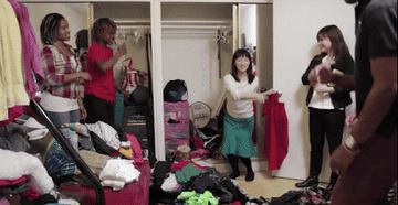 Gif of Marie Kondo and the Mersier family making the spark of joy gesture