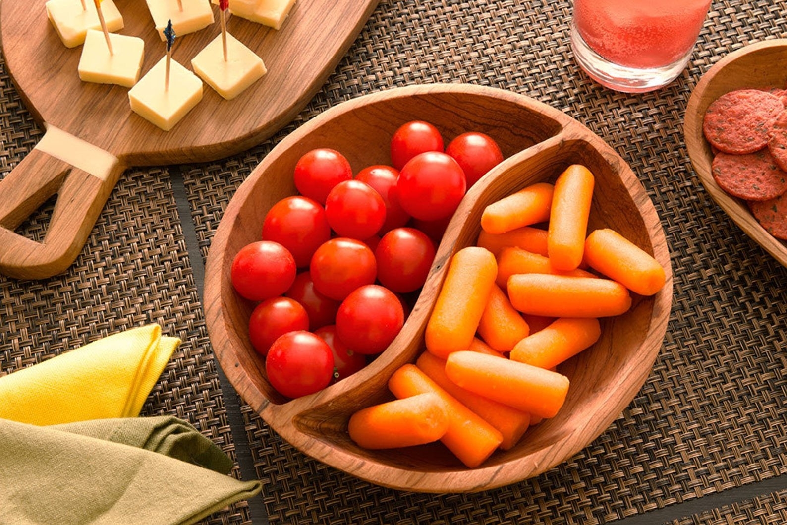 The duet serving bowl with cherry tomatoes on one side and carrots on the other