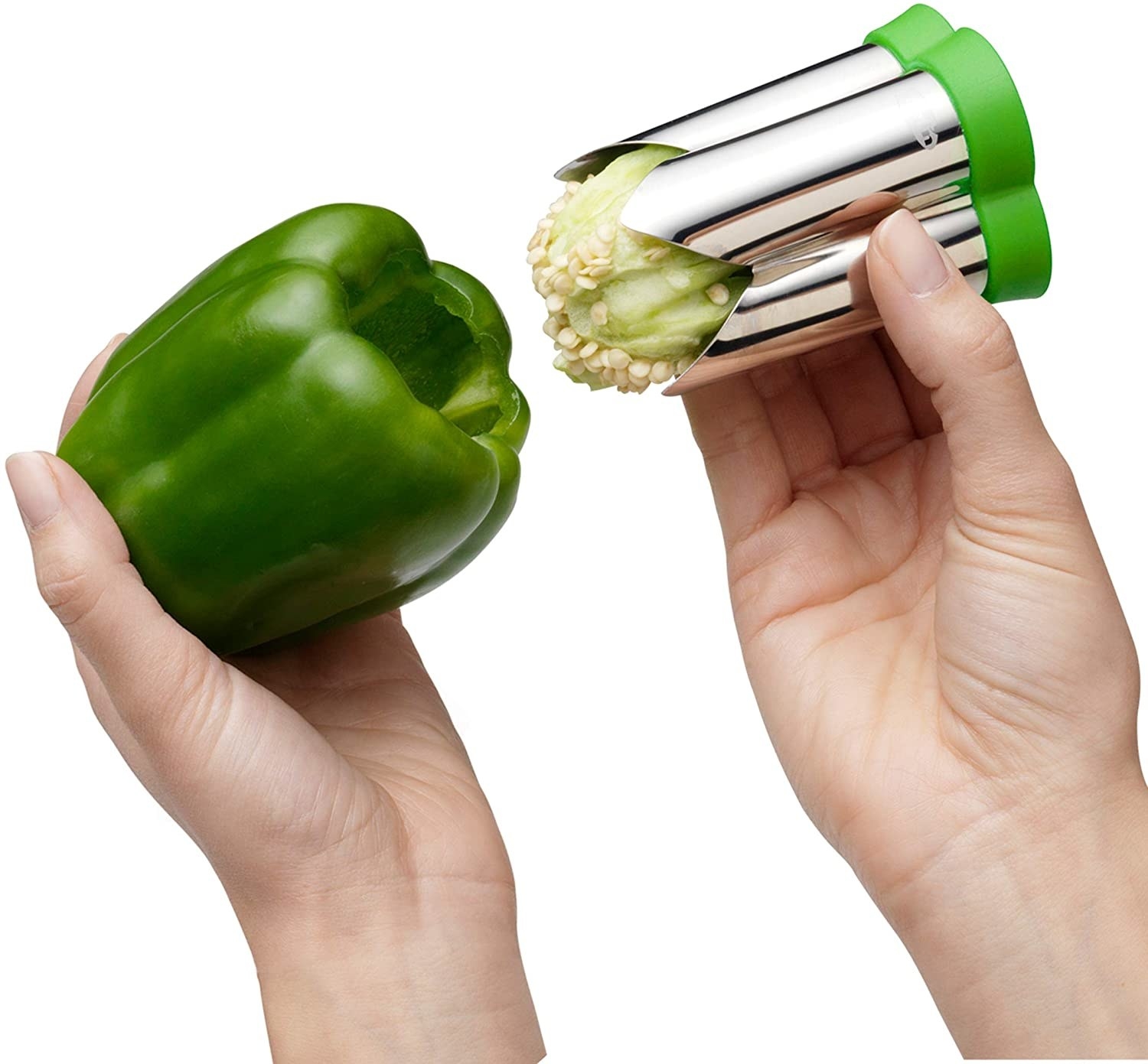 Hands holding the stainless steel corer with stem and seeds inside, and a cored pepper