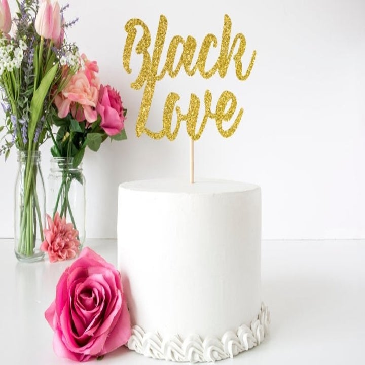 gold glitter cake topper that says "black love"