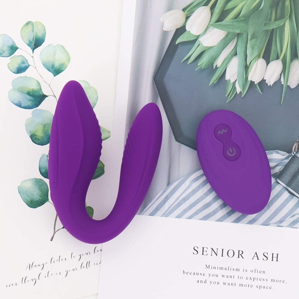 The C-shaped vibrator and it&#x27;s remote on top of a magazine