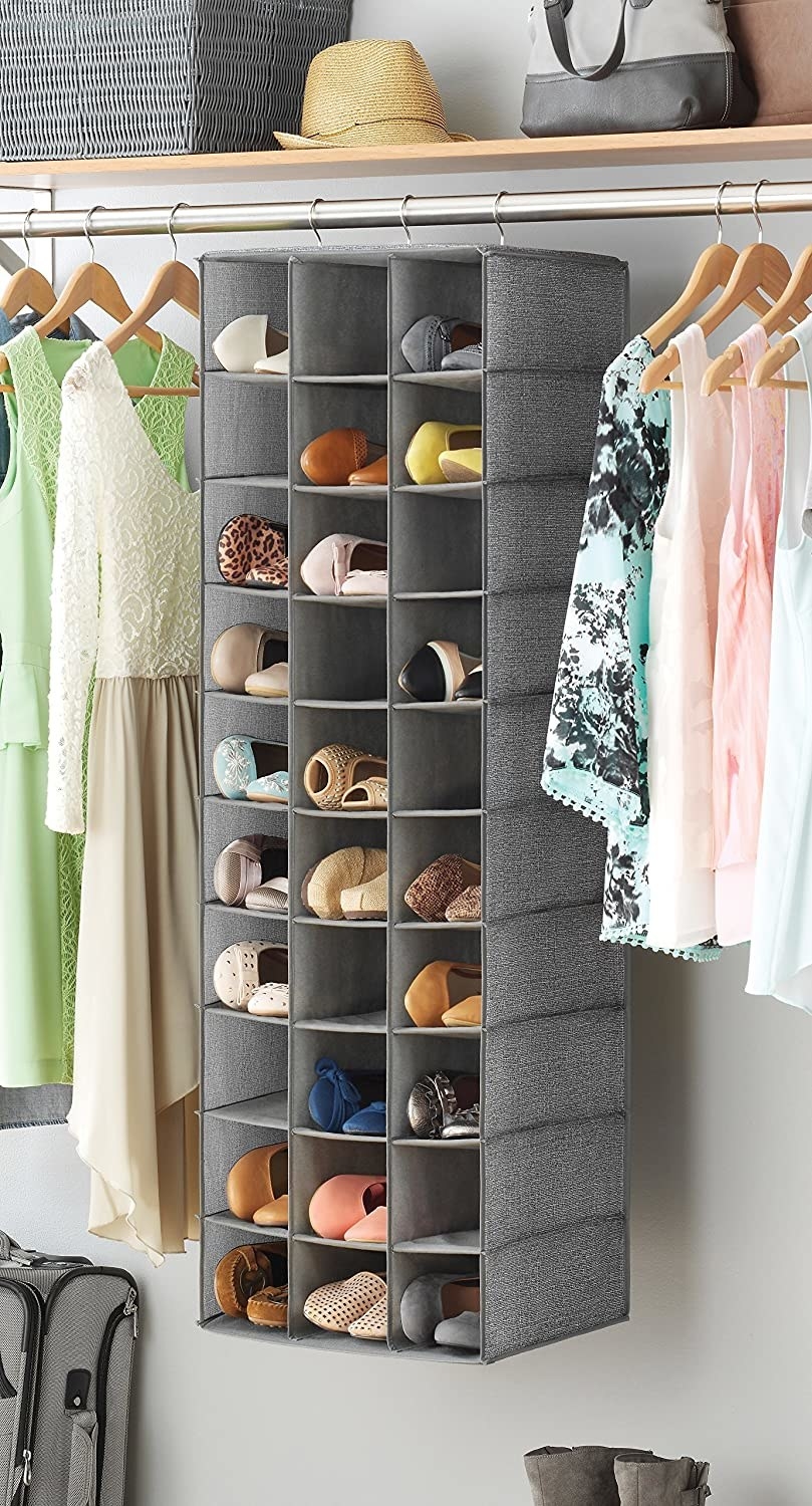 The grey fabric shoe shelf hanging inside a closet
