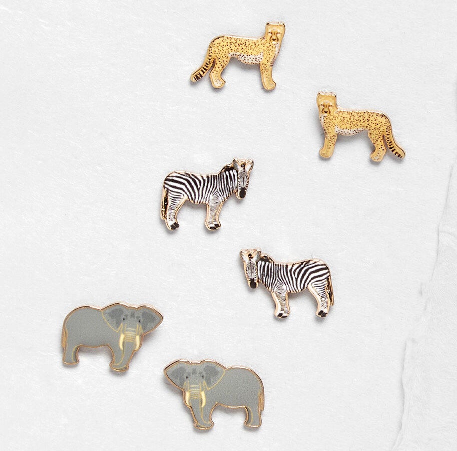 Three sets of earrings that each look like elephants, zebras, and cheetahs 