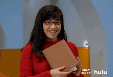 A gif of Betty from the show Ugly Betty giving a thumbs up.