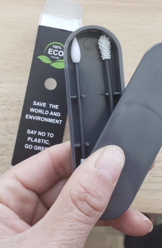 A reviewer image holding the case with two Q-tips, one with a pointed edge and one with a rough edge