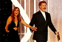 Gif of Kristen Wiig and Will Ferrell walking out on stage in amazement