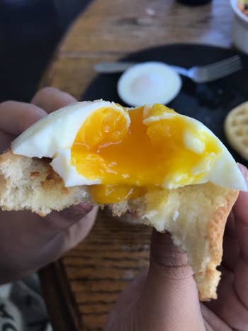 A reviewer's delicious-looking poached egg with a runny center