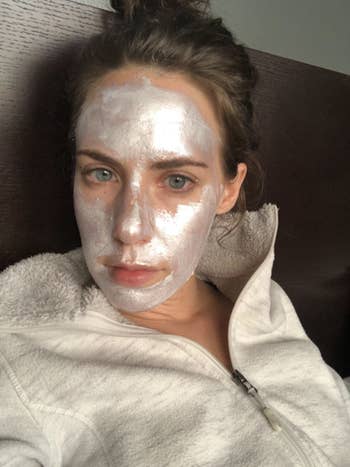 Reviewer wears I Dew Care's Disco Kitten Illuminating Diamond Peel-Off Face Mask on their face
