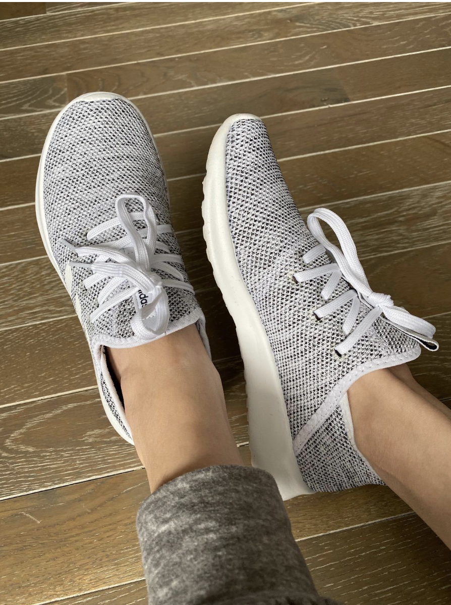 A reviewer in a pair of grey lace-up slip on sneakers 