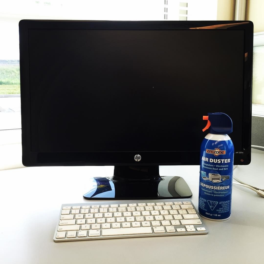 The air duster canister sits next to a keyboard