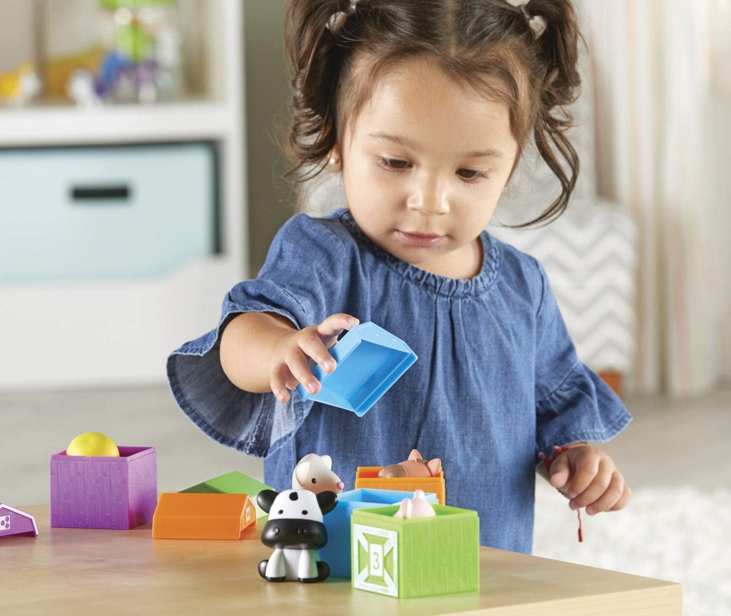 A child model playing with learning farm toys