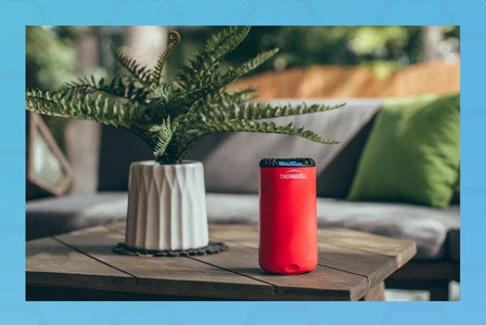 red tube-shaped electronic device on table 